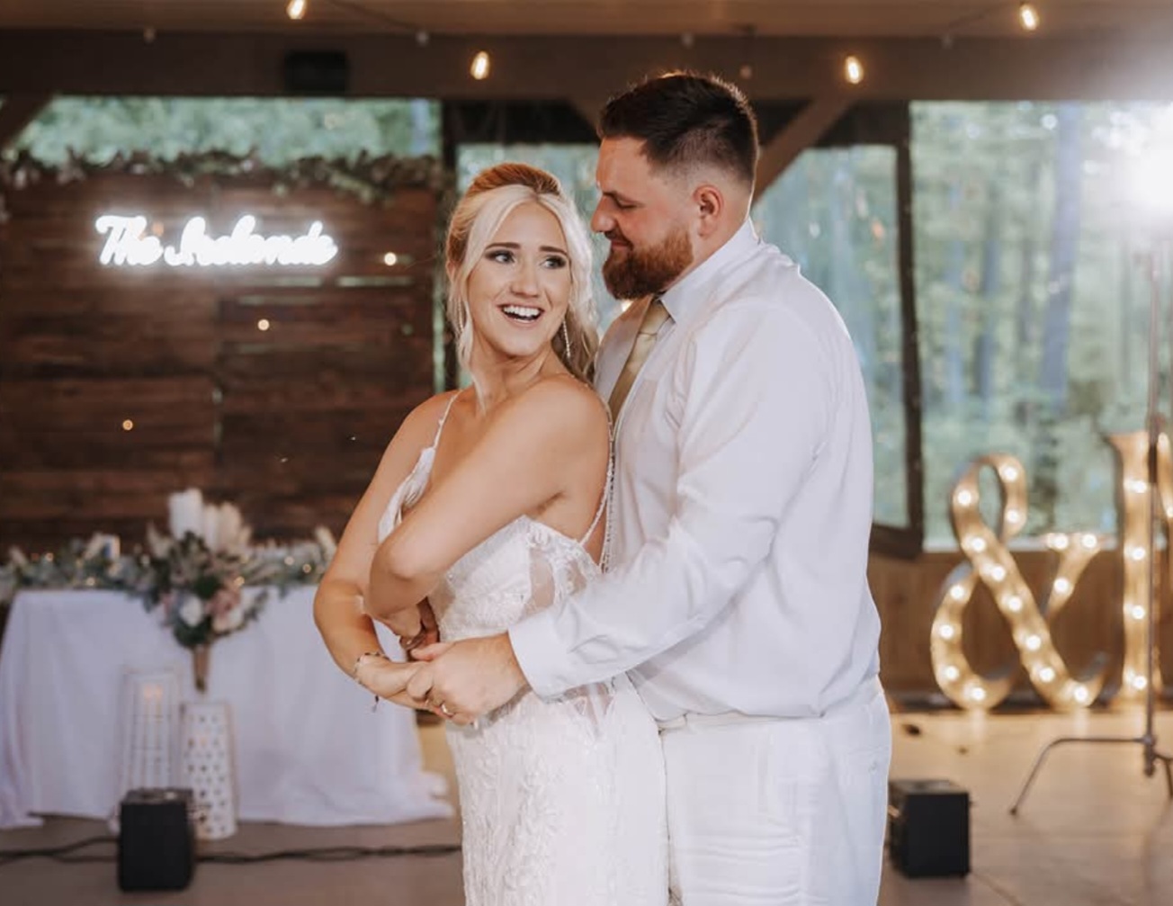 A DanceFam couple smiling together during their wedding dance